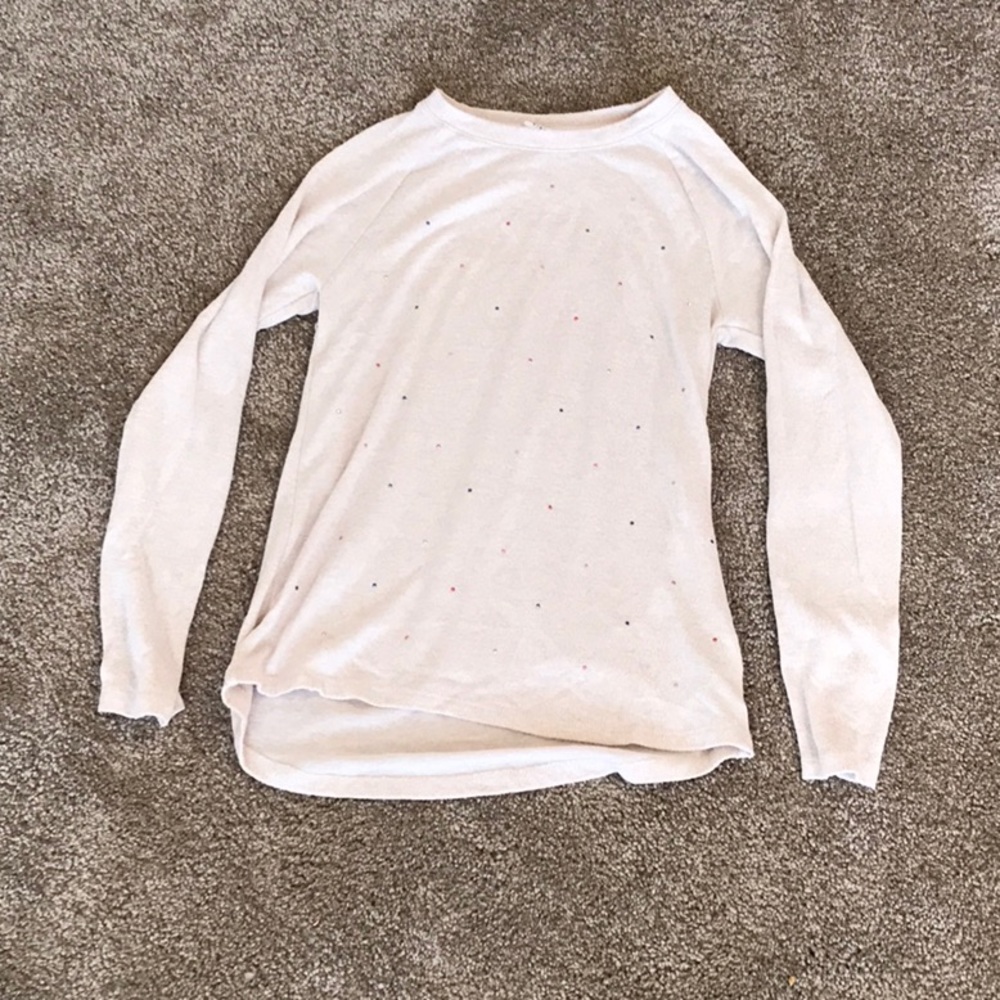 Beige gap shirt with rainbow jewels on it.